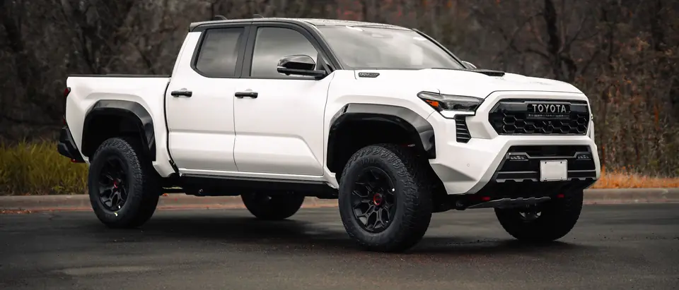 A white pickup truck parked on a paved lot